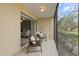 Outdoor patio with seating offers serene views of the surrounding landscape and leads into the living area at 207 Rubens Dr # D, Nokomis, FL 34275