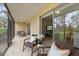 Relaxing screened patio with comfortable seating and a view into the living area at 207 Rubens Dr # D, Nokomis, FL 34275