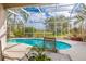 Inviting screened pool with nice patio furniture, and colorful backyard at 2091 Oakford Rd, Sarasota, FL 34240