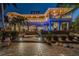 House with a large backyard, patio, and lights at night at 2127 Lusitania Dr, Sarasota, FL 34231