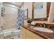 Clean bathroom with a shower/tub combo, updated vanity, and tile flooring at 2127 Lusitania Dr, Sarasota, FL 34231