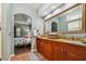 Main bathroom with double vanity, granite countertops, and a view of the bedroom at 2127 Lusitania Dr, Sarasota, FL 34231