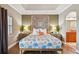Main bedroom with a large bed, ensuite bathroom access, and decorative headboard at 2127 Lusitania Dr, Sarasota, FL 34231