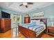 Spacious bedroom with king-size bed, hardwood floors, and private balcony access at 2127 Lusitania Dr, Sarasota, FL 34231