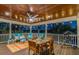 Relaxing covered deck with dining area and ceiling fan at 2127 Lusitania Dr, Sarasota, FL 34231