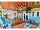 Large deck featuring comfortable seating, dining area, and tranquil views at 2127 Lusitania Dr, Sarasota, FL 34231