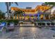 Luxury waterfront home with expansive patio and outdoor lighting at 2127 Lusitania Dr, Sarasota, FL 34231