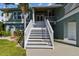 White staircase leading to the entrance of a charming waterfront home at 2127 Lusitania Dr, Sarasota, FL 34231