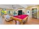 Game room with pool table, seating area, and access to outdoor space at 2127 Lusitania Dr, Sarasota, FL 34231