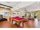 Basement game room with pool table, shuffleboard, and comfortable seating at 2127 Lusitania Dr, Sarasota, FL 34231