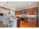 Open concept kitchen with island and hardwood floors at 2127 Lusitania Dr, Sarasota, FL 34231