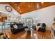 Open living area with hardwood floors, leather sofas, and a view to kitchen at 2127 Lusitania Dr, Sarasota, FL 34231