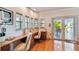 Home office with built-in desk, hardwood floors, and access to deck at 2127 Lusitania Dr, Sarasota, FL 34231