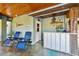 Covered outdoor bar area with seating, perfect for entertaining at 2127 Lusitania Dr, Sarasota, FL 34231
