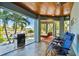 Relaxing outdoor patio with water views, comfortable seating, and a grill at 2127 Lusitania Dr, Sarasota, FL 34231