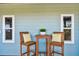 Charming patio seating area with two wooden chairs and a small table at 2127 Lusitania Dr, Sarasota, FL 34231