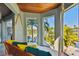 Relaxing porch swing with yellow and teal pillows, overlooking the water at 2127 Lusitania Dr, Sarasota, FL 34231