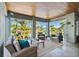 Spacious sunroom with wicker furniture and water views at 2127 Lusitania Dr, Sarasota, FL 34231