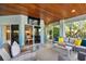 Bright sunroom with comfortable seating and access to the outdoors at 2127 Lusitania Dr, Sarasota, FL 34231
