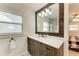 Bathroom with a marble-topped vanity, rustic wood framed mirror, and a walk-in shower at 2160 17Th W St, Palmetto, FL 34221