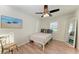 Bedroom with wood-look flooring, ceiling fan, and large mirror at 2160 17Th W St, Palmetto, FL 34221