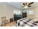 Comfortable bedroom featuring a ceiling fan, dresser, and plaid bedding at 2160 17Th W St, Palmetto, FL 34221