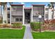Exterior view of condo building with landscaped grounds at 3267 Beneva Rd # 103, Sarasota, FL 34232