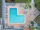 L-shaped community pool with lounge chairs at 3267 S Beneva Rd # 103, Sarasota, FL 34232