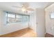 Bright bedroom with wood floors, ceiling fan, and ample closet space at 3403 Overcup Oak Ter, Sarasota, FL 34237