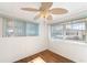 Well-lit bedroom with wood floors and dual window views at 3403 Overcup Oak Ter, Sarasota, FL 34237