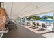 Covered patio area with picnic tables and rocking chairs at 3403 Overcup Oak Ter, Sarasota, FL 34237