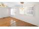 Simple dining area with hardwood floors and a light fixture at 3403 Overcup Oak Ter, Sarasota, FL 34237