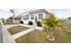 White single-wide manufactured home with landscaped yard and walkway at 3403 Overcup Oak Ter, Sarasota, FL 34237