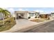 Single-wide manufactured home with carport and landscaping at 3403 Overcup Oak Ter, Sarasota, FL 34237