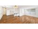 Open kitchen and dining area with white cabinets and hardwood floors at 3403 Overcup Oak Ter, Sarasota, FL 34237