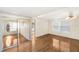 Spacious living area featuring hardwood floors and mirrored sliding doors at 3403 Overcup Oak Ter, Sarasota, FL 34237