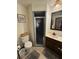 Bathroom with shower, toilet, and wood vanity at 3455 Gardenia St, Sarasota, FL 34237