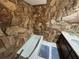 Bathroom with stone wall and a bathtub at 3455 Gardenia St, Sarasota, FL 34237