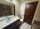 Clean bathroom with stone wall accents and updated vanity at 3455 Gardenia St, Sarasota, FL 34237