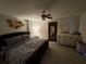 Main bedroom with plush bed, dresser, and ceiling fan at 3455 Gardenia St, Sarasota, FL 34237