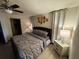 Main bedroom with plush bed, dresser, and ceiling fan at 3455 Gardenia St, Sarasota, FL 34237