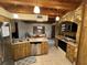 Open kitchen with wood cabinets, stone accent wall, and stainless steel appliances at 3455 Gardenia St, Sarasota, FL 34237