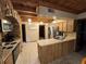 Open kitchen with wood cabinets, stone accent wall, and stainless steel appliances at 3455 Gardenia St, Sarasota, FL 34237