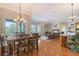 Bright dining area with a wood table and chairs, opens to living room at 4678 Silent Creek Way, Nokomis, FL 34275