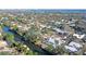Aerial view of a waterfront home with a pool and lush landscaping at 5072 Higel Ave, Sarasota, FL 34242