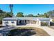 Newly renovated home with a metal roof and paver driveway at 5072 Higel Ave, Sarasota, FL 34242