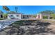 Updated home exterior, featuring a paver driveway at 5072 Higel Ave, Sarasota, FL 34242