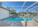 Inviting pool area with screened enclosure overlooking the canal at 5072 Higel Ave, Sarasota, FL 34242