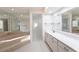 Primary bathroom with a large soaking tub, walk-in shower, and double vanity at 5131 Willow Leaf Dr, Sarasota, FL 34241