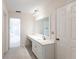 Bathroom features a vanity with marble countertop and a large mirror at 5131 Willow Leaf Dr, Sarasota, FL 34241